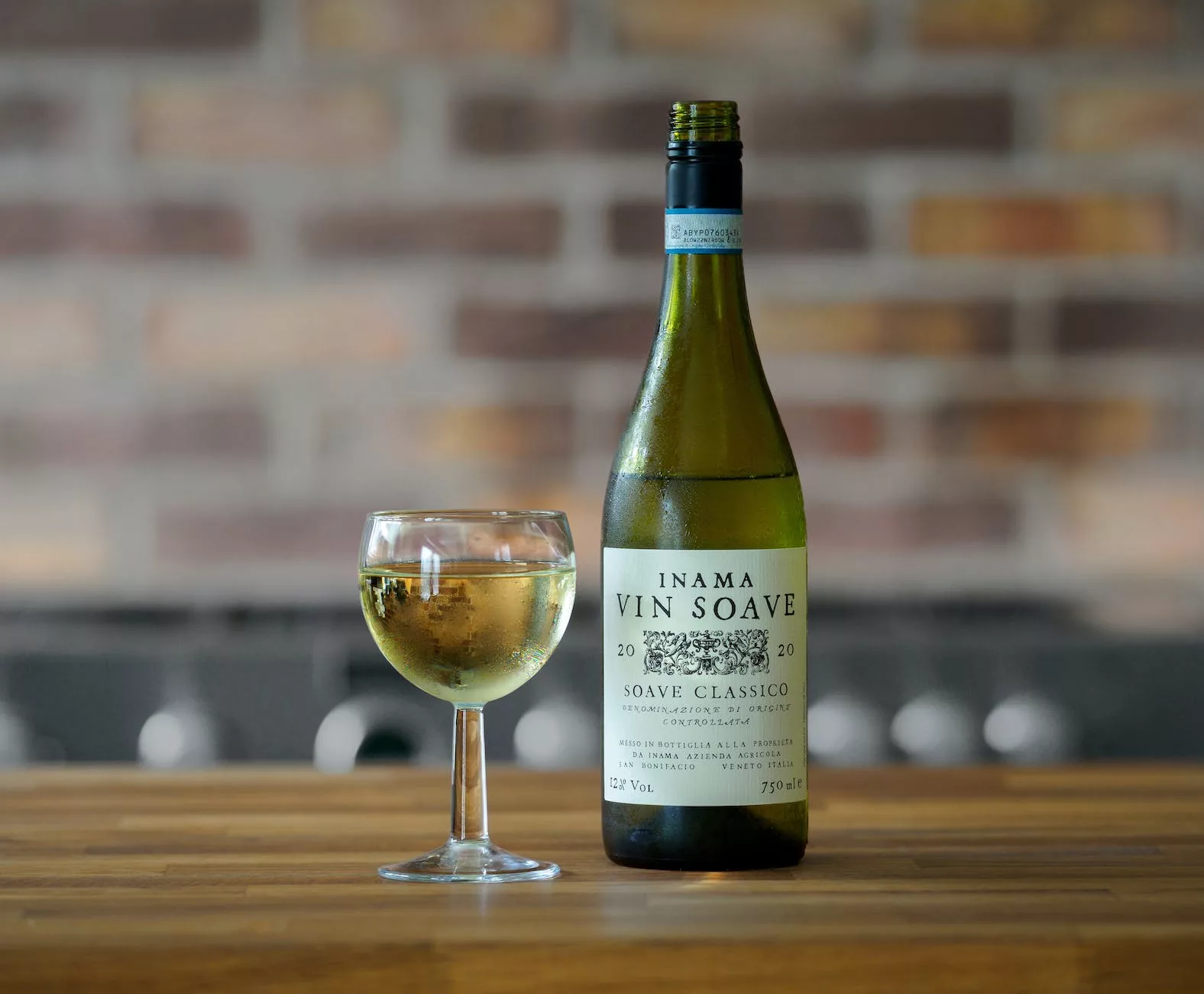 Vin blanc suave ne bouteille avec un verre sur une surface en bois